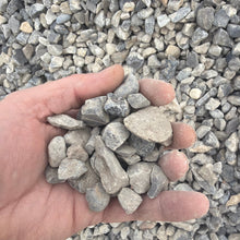Load image into Gallery viewer, Hand holding small stones against a background of similar stones