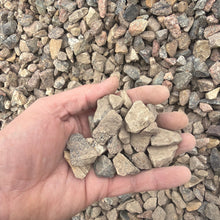 Load image into Gallery viewer, Hand holding small stones with a background of gravel