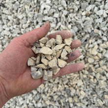 Load image into Gallery viewer, Hand holding small stones against a background of gravel