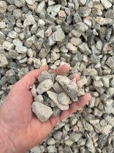 Load image into Gallery viewer, Hand holding small stones with a background of gravel