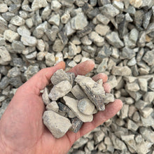 Load image into Gallery viewer, Hand holding small stones with a background of gravel