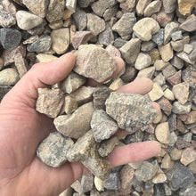Load image into Gallery viewer, Hand holding small stones amidst a pile of gravel