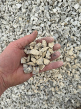 Load image into Gallery viewer, Hand holding small stones against a background of gravel
