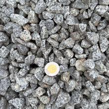 Load image into Gallery viewer, Close-up of gray gravel with a white light bulb in the center
