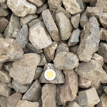 Load image into Gallery viewer, Pile of gray stones with a small white circle in the center
