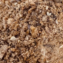 Close-up of brown sand with small stones
