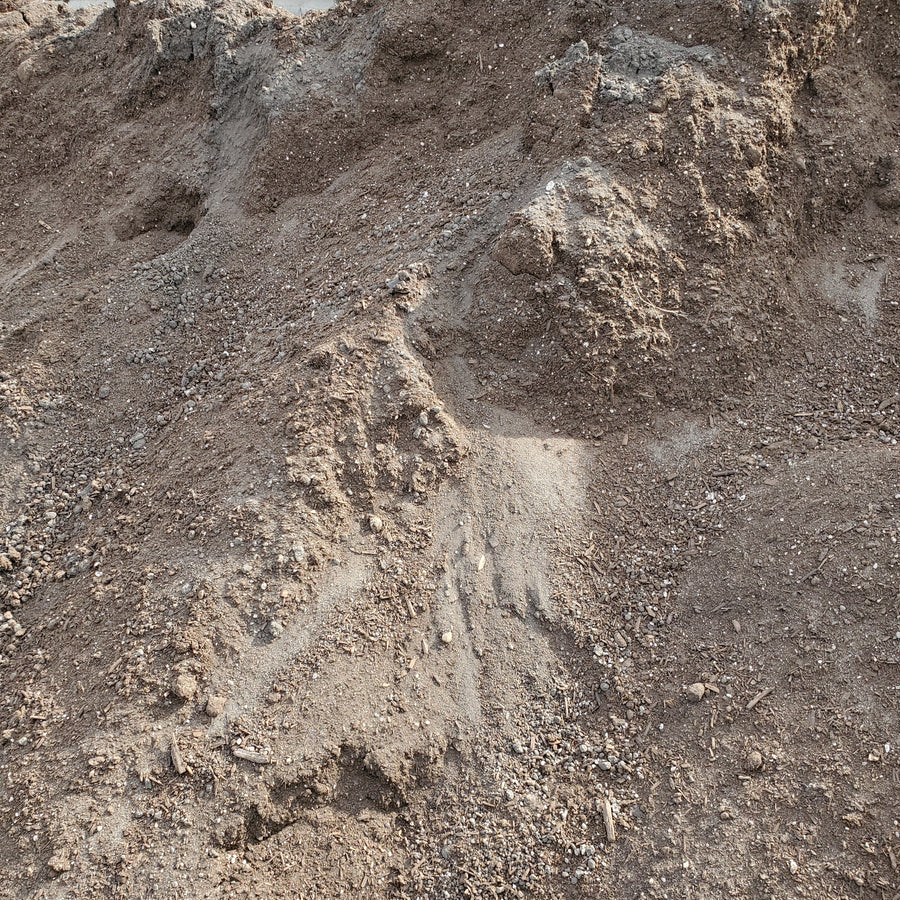 A pile of brown premium garden mix soil.